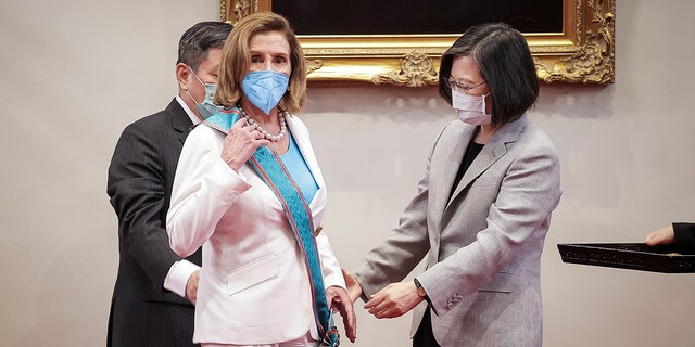 Speaker of the U.S. House Of Representatives Nancy Pelosi (D-CA), center, receives the Order of Propitious Clouds with Special Grand Cordon, Taiwan’s highest civilian honour, from Taiwan's President Tsai Ing-wen, right, at the president's office on August 03, 2022, in Taipei, Taiwan. 