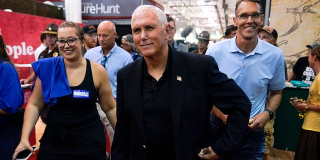 Former Vice President Mike Pence walks through the Varied Industries Building during a visit to the Iowa State Fair, Friday, Aug. 19, 2022, in Des Moines, Iowa. 