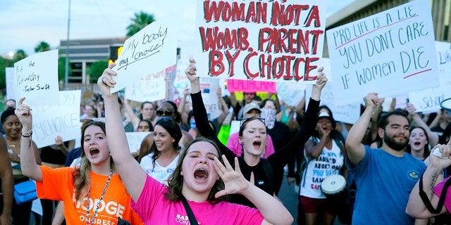 Protesters shout as they join thousands marching around the Arizona Capitol after the Supreme Court overturned the landmark Roe v. Wade abortion decision.