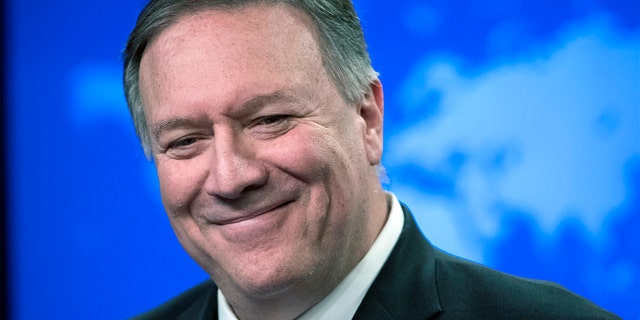 Secretary of State Mike Pompeo smiles as he speaks with reporters at the State Department in Washington on Nov. 26, 2019.