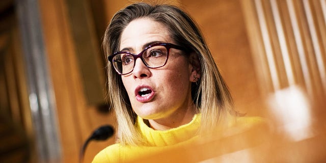 Sen. Kyrsten Sinema, a Democrat from Arizona, is facing backlash from progressives over her move to eliminate the carried interest tax loophole used by wealthy Americans from the Inflation Reduction Act.