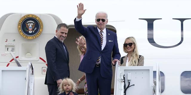 President Joe Biden, center, waves as he is joined by, from left, son Hunter Biden, grandson Beau Biden, first lady Jill Biden, and daughter-in-law Melissa Cohen