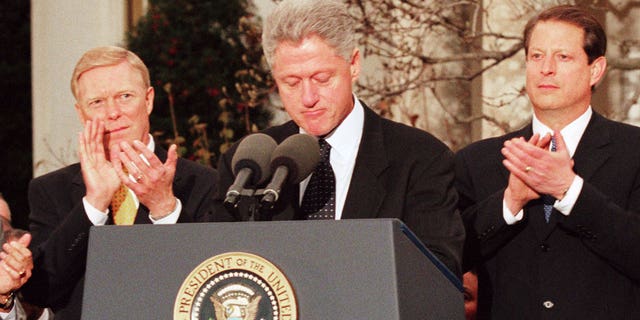 President Bill Clinton reacts to being impeached by the House of Representatives 