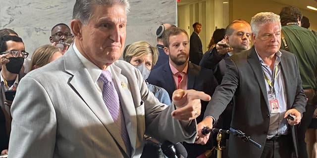 Sen. Joe Manchin, D-W.Va., calls on a reporter during a press conference about Democrats' reconciliation bill. 