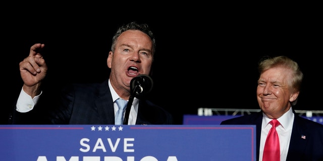 Wisconsin Republican gubernatorial candidate Tim Michels, left speaks as former President Donald Trump, right, listens at a rally Aug. 5, 2022, in Waukesha, Wisconsin.