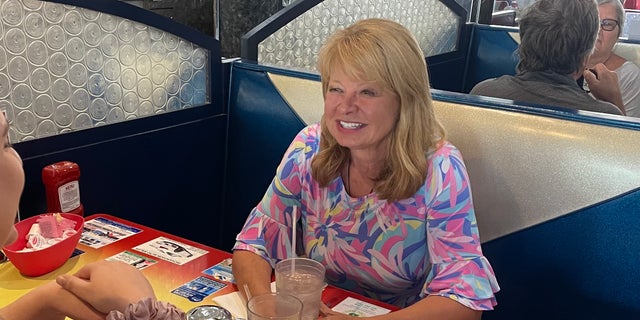 Republican U.S. House candidate Gail Huff Brown, who is running in New Hampshire's 1st Congressional District, speaks with voters at MaryAnn's Diner in Derry, New Hampshire, on Sept. 12, 2022