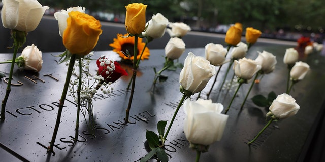 Flowers are seen on the names of the victims of the 9/11 terror attack at the North Tower Memorial Pool during the annual 9/11 Commemoration Ceremony at the National 9/11 Memorial and Museum on September 11, 2022, in New York City.