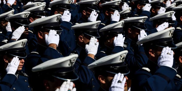 Air Force Academy cadets salute during the national anthem at Falcon Stadium for their graduation ceremony on May 25, 2022, in Colorado Springs, Colorado.