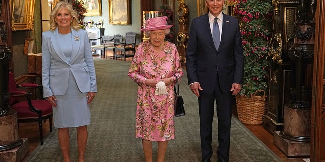 Britain's Queen Elizabeth stands with U.S. President Joe Biden and first lady Jill Biden in the Grand Corridor during their visit at Windsor Castle, in Windsor, Britain, June 13, 2021. (Steve Parsons/Pool via REUTERS)