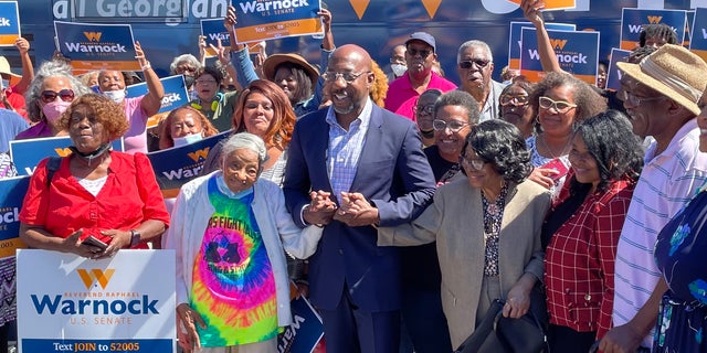 Sen. Raphael Warnock of Georgia, with supporters at a rally for seniors in Atlanta on Sept. 26.