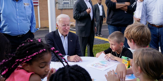 President Joe Biden sits and talks to children before speaking at a United Steelworkers of America Local Union 2227 event in West Mifflin, Pennsylvania, on Sept. 5, 2022.