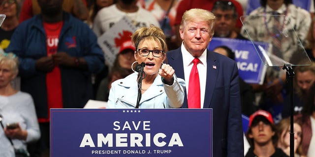 Former Alaska Gov. Sarah Palin speaks as former President Donald Trump looks on during a "Save America" rally on July 9, 2022, in Anchorage, Alaska.