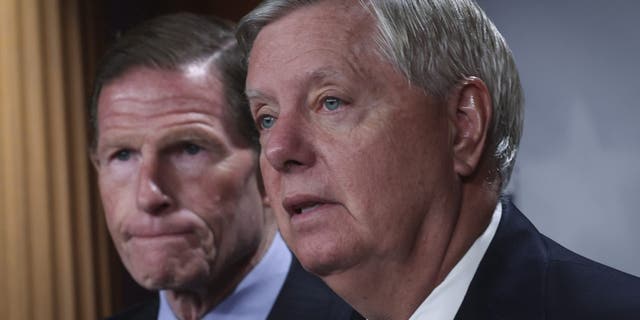 Sen. Richard Blumenthal listens as Sen. Lindsey Graham speaks during a press conference at the U.S. Capitol, May 10, 2022.