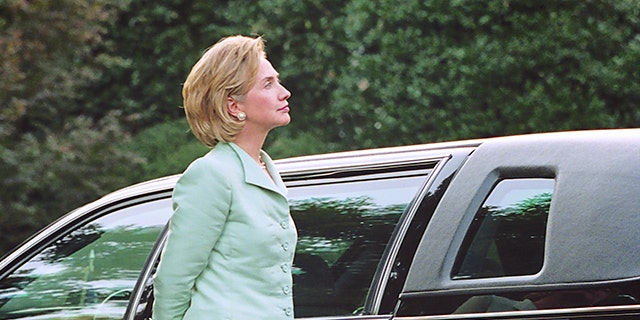 First Lady Hillary Clinton waits for her husband outside the White House on their way to a Democratic Business Leaders event, the day after Special Prosecutor Kenneth Starr sent his report of impeachable offenses to Congress, in Washington, DC, on Sept. 10, 1998. 