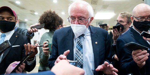 Sen. Bernie Sanders speaks with reporters in the Senate subway on Dec. 13, 2021.