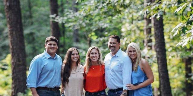 Rep. Marjorie Taylor Greene, R-Ga., poses for a picture with her husband Perry Greene and their three children in March 2020.