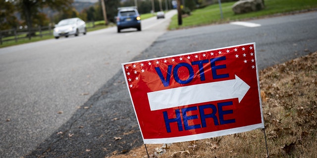 A "Vote Here" sign along the road in Hunterdon County, New Jersey, U.S., on Tuesday, Nov. 2, 2021.