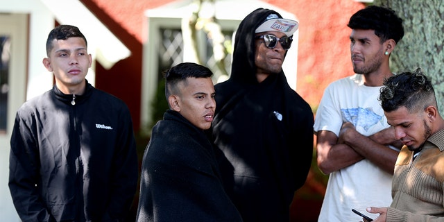 A handful of migrants are seen outside St. Andrews Episcopal Church Thursday at Martha's Vineyard in Massachusetts.