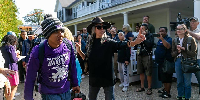 A Venezuelan migrant is led onto a bus at St. Andrew's Episcopal Church on Friday, Sept. 16, 2022, in Edgartown, Massachusetts, on the island of Marthaâs Vineyard.