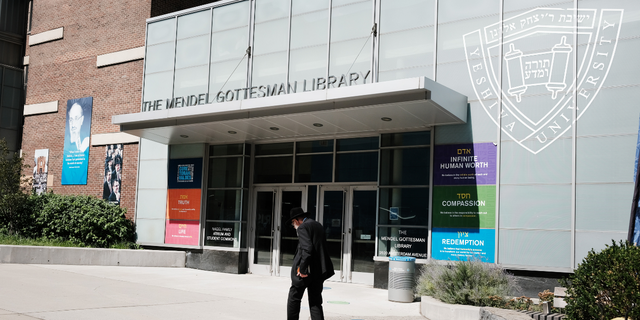 People walk by the campus of Yeshiva University in New York City.