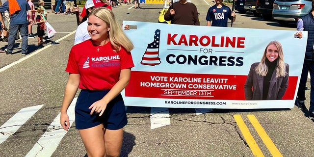 Republican congressional candidate Karoline Leavitt marches in a parade in Gilford, New Hampshire on August 27, 2022