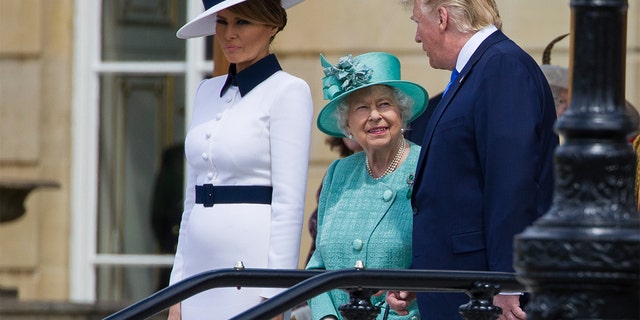 First lady Melania Trump, left, stands as Queen Elizabeth II smiles while talking with President Donald Trump at Buckingham Palace, Monday, June 3, 2019, in London.