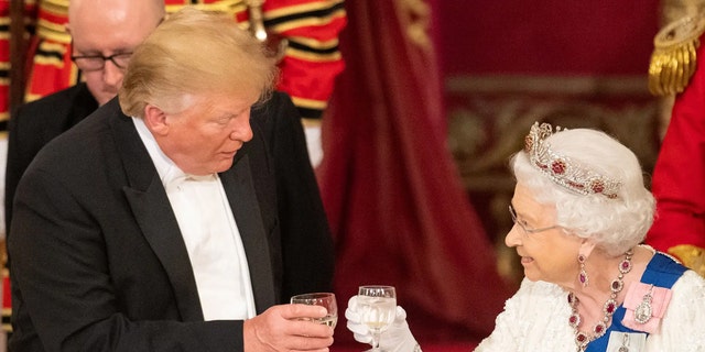 Britain's Queen Elizabeth II raised a glass with US President Donald Trump during a state banquet in the ballroom at Buckingham Palace on June 3, 2019 