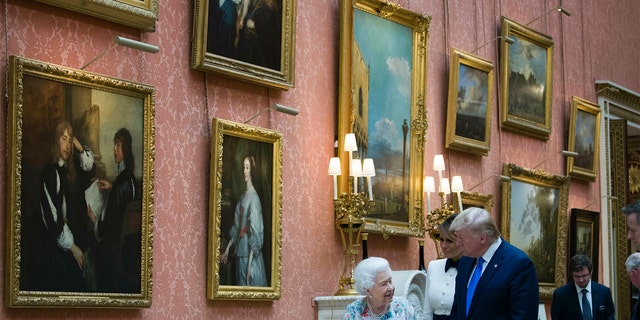 Queen Elizabeth II shows items in the Royal Gifts collection to first lady Melania Trump and President Donald Trump at Buckingham Palace, Monday, June 3, 2019, in London.