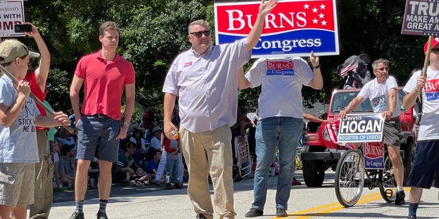 Republican congressional candidate Bob Burns marches in the Amherst, New Hampshire, Independence Day parade, on July 4, 2022.