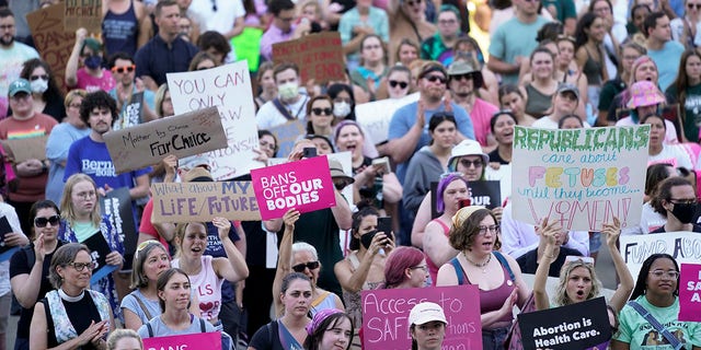 Abortion rights protesters cheer at a rally outside the state capitol in Lansing, Michigan, June 2022, following the United States Supreme Court's decision to overturn Roe v. Wade.