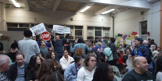 Rep. Alexandria Ocasio-Cortez, D-N.Y., faces down protesters at a town hall event in New York City.