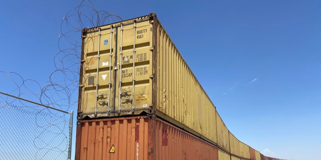 Construction to place these shipping containers in gaps in the border wall began in Yuma, Arizona. Republican Gov. Doug Ducey of Arizona is suing the Biden administration over an order to remove shipping containers used to fill gaps at the southern border.