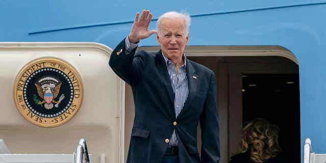 President Joe Biden waves before boarding Air Force One for a trip to Florida to visit areas impacted by Hurricane Ian, Wednesday, Oct. 5, 2022, at Andrews Air Force Base, Md. 