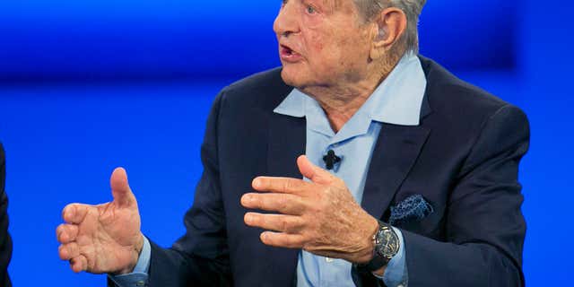 In this Sept. 27, 2015, file photo, George Soros, chairman of Soros Fund Management, talks during a television interview for CNN at the Clinton Global Initiative in New York.