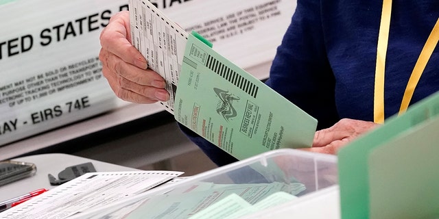 Election workers sort ballots on Oct. 21, 2020, at the Maricopa County Recorder's Office in Phoenix, Arizona.