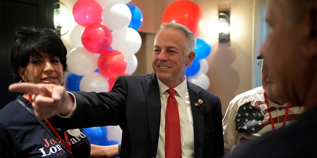 Republican candidate for Nevada governor, Joe Lombardo, center, is a former Clark County Sheriff. 