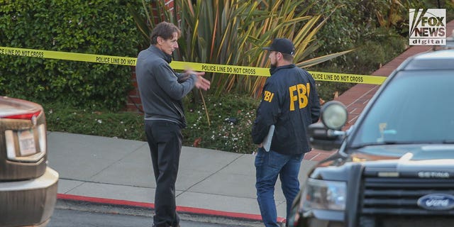 Paul Pelosi Jr. speaks to FBI investigators outside the home of his parents, Nancy and Paul Pelosi, Friday, October 28, 2022. His father, Paul was the victim of a violent home invasion earlier that morning.