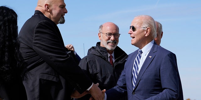 President Joe Biden speaks with Pennsylvania Lt. Gov. John Fetterman Thursday, Oct. 20, 2022, at the 171st Air Refueling Wing at Pittsburgh International Airport in Coraopolis, Pa. 