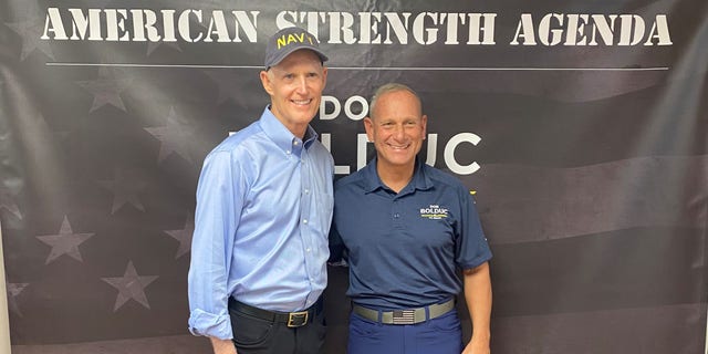 Sen. Rick Scott, the chair of the National Republican Senatorial Committee, teams up on the campaign trail with GOP Senate nominee Don Bolduc on Oct. 30, 2022, in Atkinson, New Hampshire.