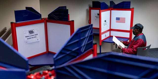 Cornelius Whiting votes early at a polling location in Alexandria, Va., in September.