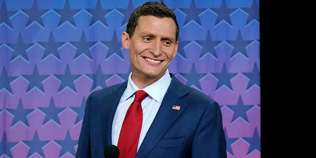 Republican Arizona Senate nominee Blake Masters smiles on stage prior to a televised debate with Arizona Democratic Sen. Mark Kelly and Libertarian candidate Marc Victor in Phoenix.