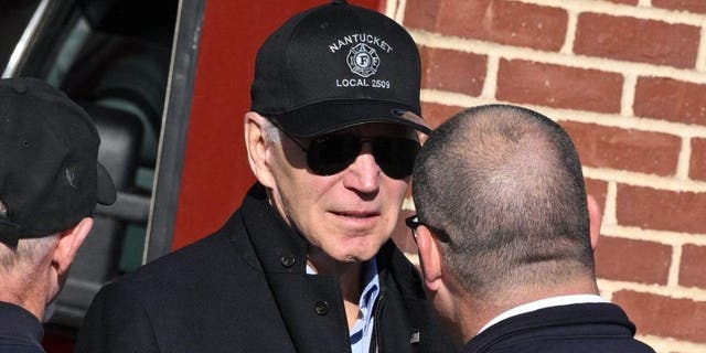 President Biden speaks with firefighters as he visits a Nantucket, Massachusetts, fire station to thank first responders during the Thanksgiving Day holiday, on Nov. 24, 2022.