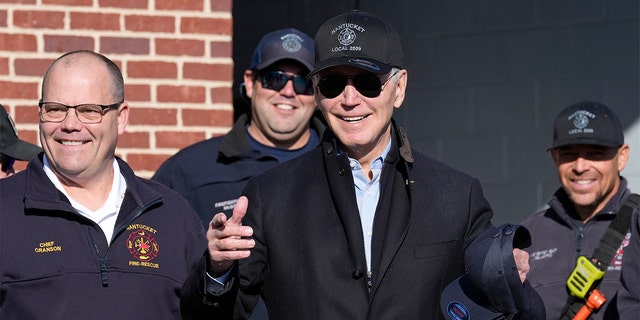 President Biden, standing next to Nantucket Fire Department Chief Michael Cranson, left, talks during a visit with firefighters on Thanksgiving Day at the Nantucket Fire Department in Nantucket, Massachusetts, Thursday, Nov. 24, 2022.