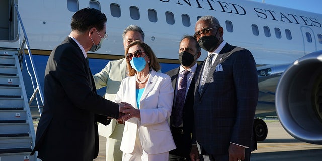 Taiwan's Foreign Minister Joseph Wu, left, speaks with U.S. House Speaker Nancy Pelosi as she prepares to leave in Taipei, Taiwan, Wednesday, Aug. 3, 2022.