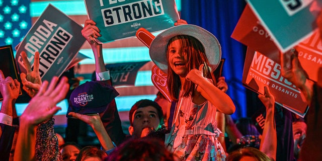 Supporters of Republican gubernatorial candidate for Florida Ron DeSantis cheer during an election night watch party at the Convention Center in Tampa, Florida, on November 8, 2022.