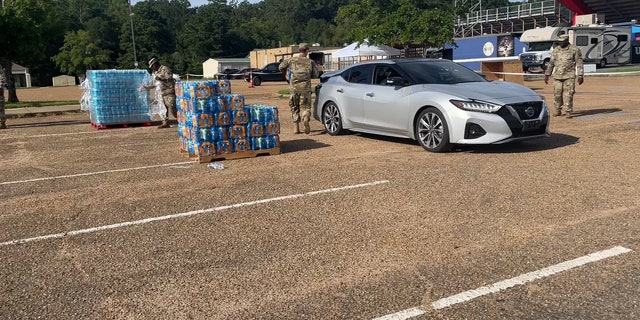 Water donation sites give residents bottled water for consumption.