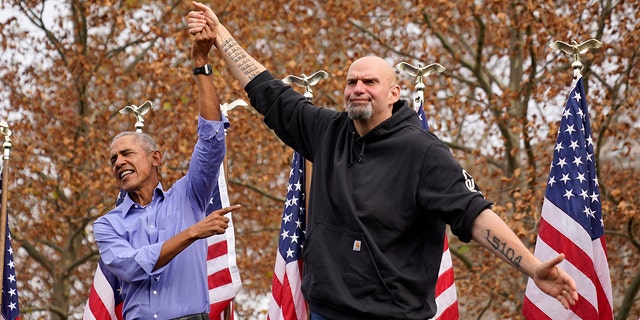 Former President Barack Obama, left, finishes his remarks and welcomes Pennsylvania Lt. Gov. John Fetterman, a Democratic candidate for U.S. Senate, to the stage during a campaign rally in Pittsburgh, Saturday, Nov. 5, 2022. 