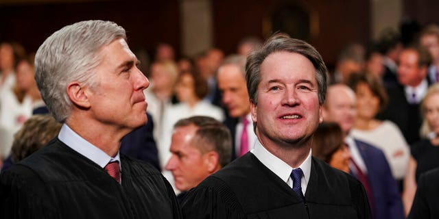 In this Feb. 5, 2019, file photo, Supreme Court Associate Justices Neil Gorsuch, left, and Brett Kavanaugh watch as President Donald Trump arrives to give his State of the Union address to a joint session on Congress at the Capitol in Washington. 