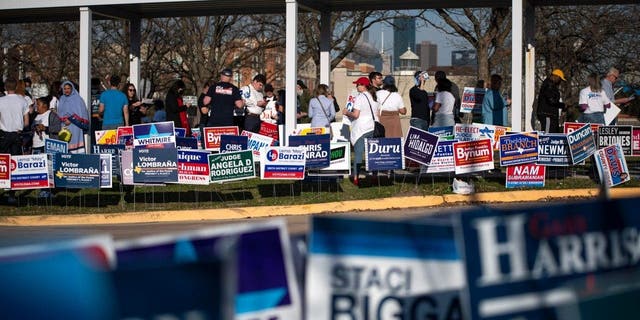 Voters wait in line outside the Metropolitan Multi-Service Center polling place in Houston, Texas, on March 1, 2022.