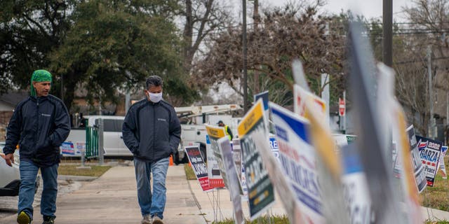 People walk to cast their ballot at the Moody Community Center on Feb. 24, 2022, in Houston.